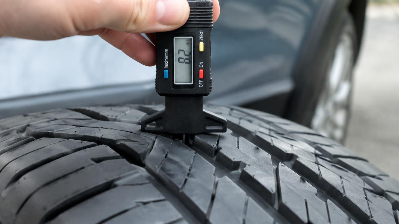 Digital tread depth gauge measuring the deep tread on a new tyre