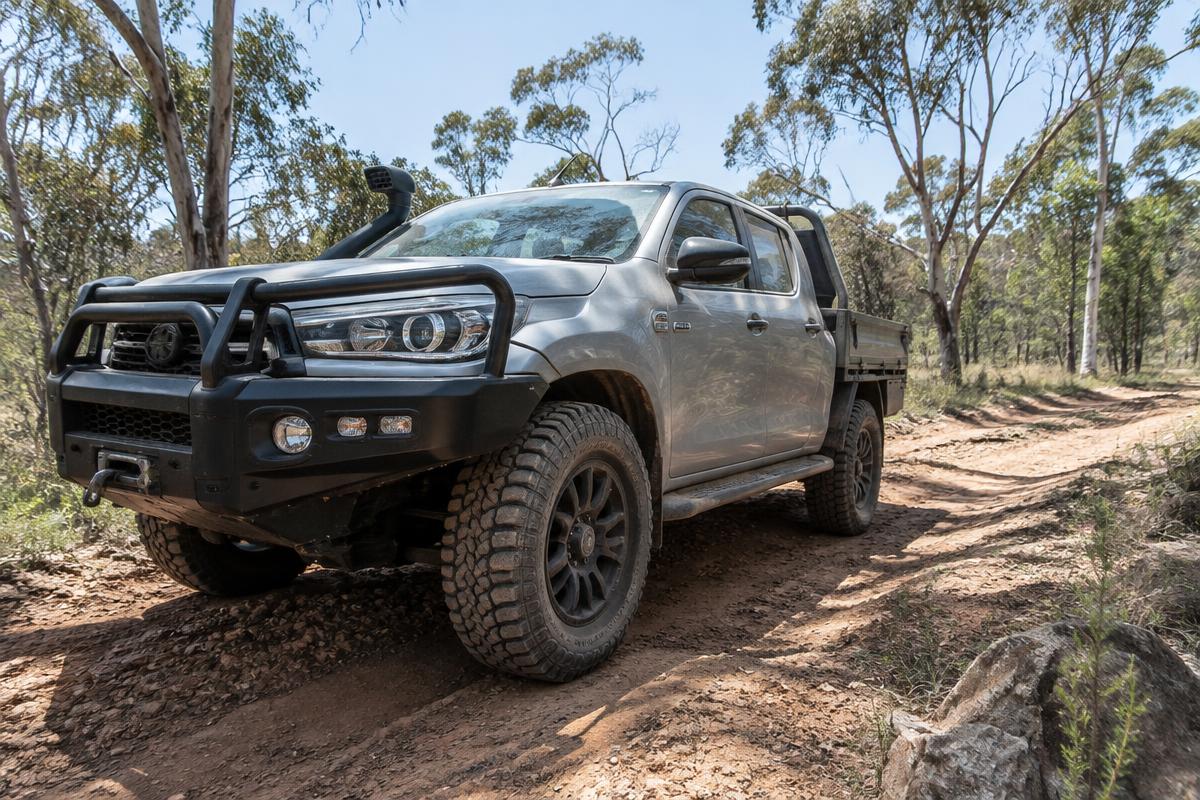 Close-up of the all-terrain tyre on a grey dual-cab 4WD ute with a bull bar.